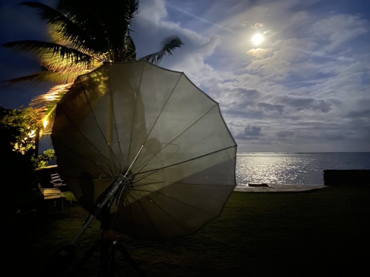 Dish and moon with ocean in background